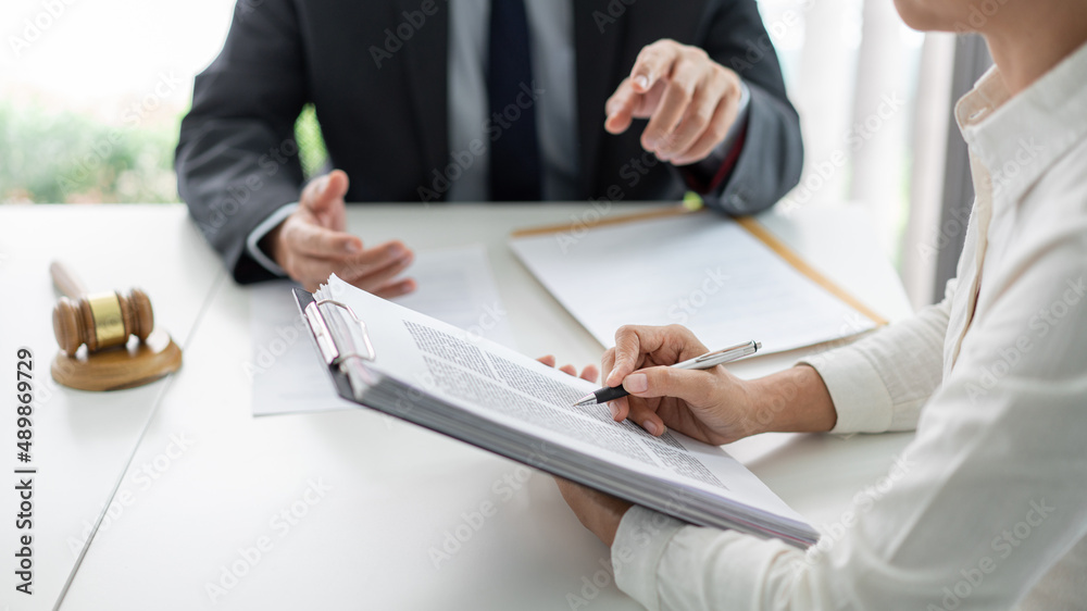 law concept the lawyer partner who wears simple white shirt attempting to catch up and write down from what her boss says law concept the lawyer partner who wears simple white shirt attempting to catch up and write down from what her boss says