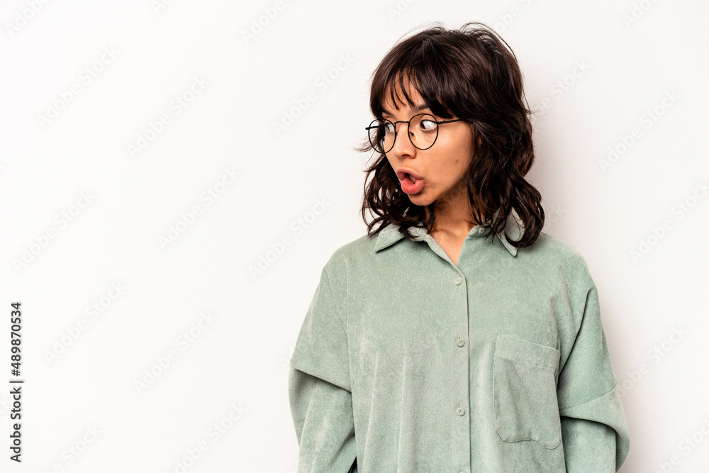 Young hispanic woman isolated on white background being shocked because of something she has seen.