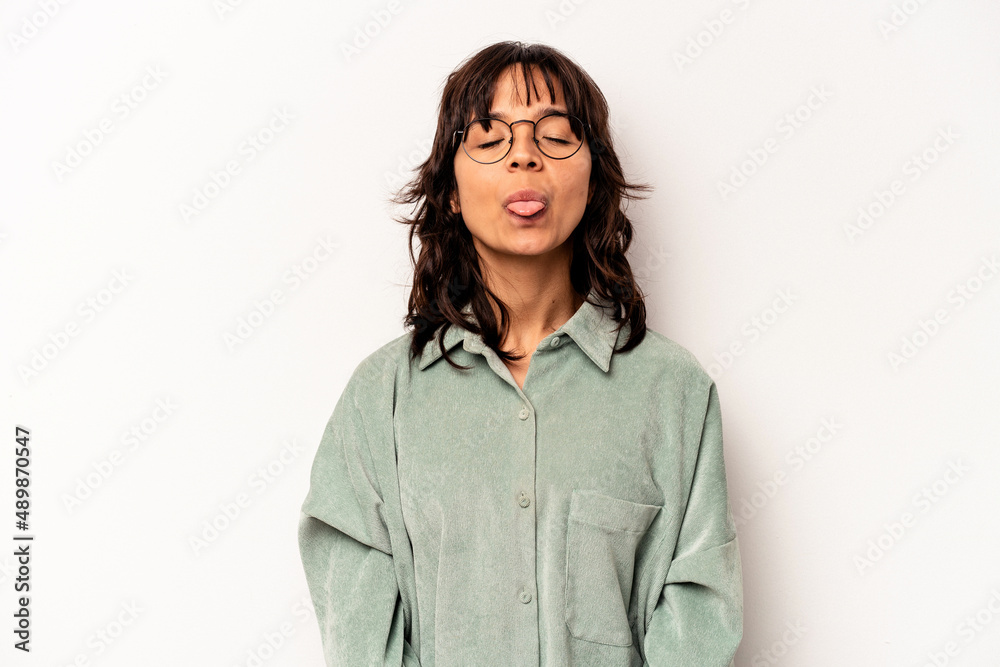 Young hispanic woman isolated on white background funny and friendly sticking out tongue. Young hispanic woman isolated on white background funny and friendly sticking out tongue.