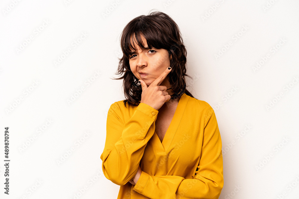 Young hispanic woman isolated on white background contemplating, planning a strategy, thinking about the way of a business. Young hispanic woman isolated on white background contemplating, planning a strategy, thinking about the way of a business.