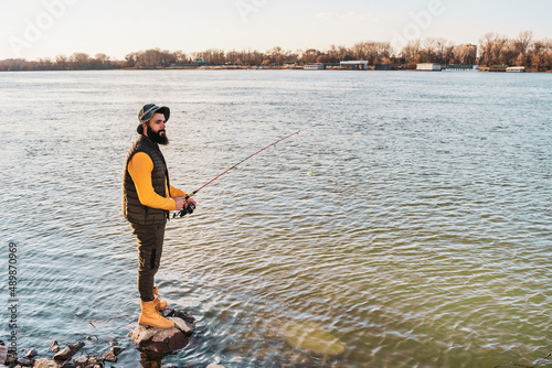 Man enjoys fishing at the river.