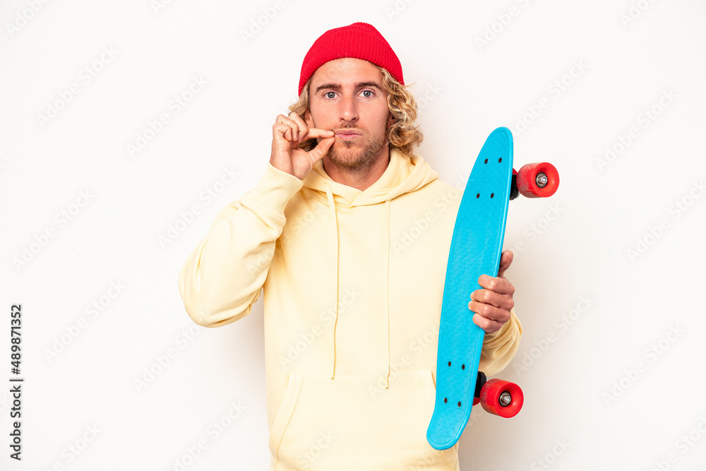 Young skater caucasian man isolated on white background with fingers on lips keeping a secret. Young skater caucasian man isolated on white background with fingers on lips keeping a secret.