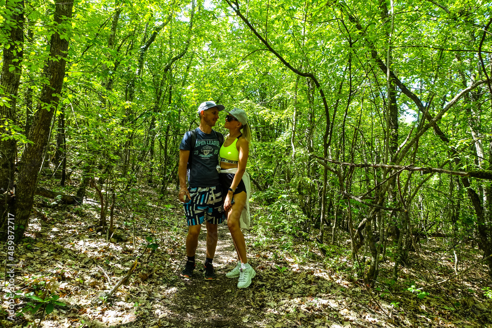 A man with a girl in the forest near the cave town of Tepe-Kermen Crimea Russia 2021