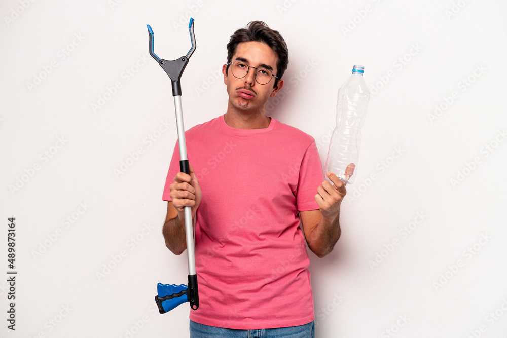 Young caucasian man holding a garbage collector isolated on white background Young caucasian man holding a garbage collector isolated on white background
