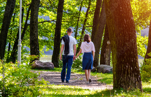 A guy and a girl walk along the path in the city Park 