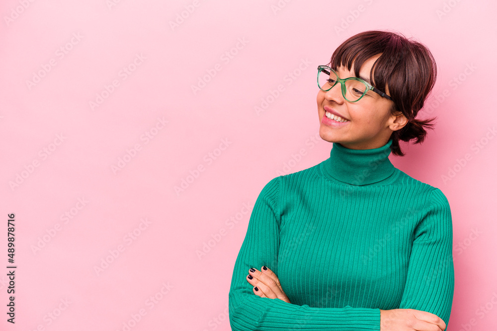 Young hispanic woman isolated on pink background smiling confident with crossed arms. Young hispanic woman isolated on pink background smiling confident with crossed arms.