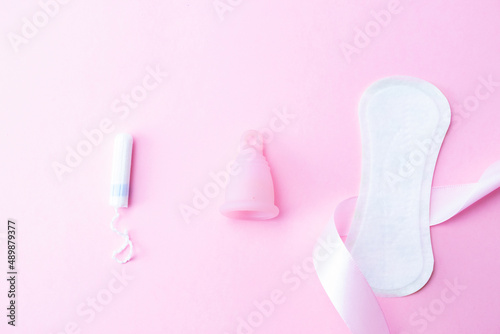 Menstrual cup, tampon, woman cup for sanitary protection. Pink ribbon with menstrual cup. Menstruation feminine period. Zero waste concept, ecofriendly lifestyle, reduced banner consumption.