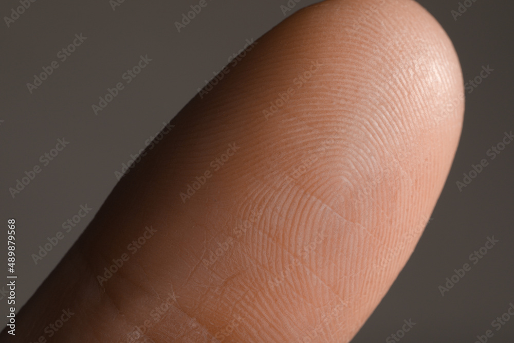 Closeup view of human finger on grey background Closeup view of human finger on grey background