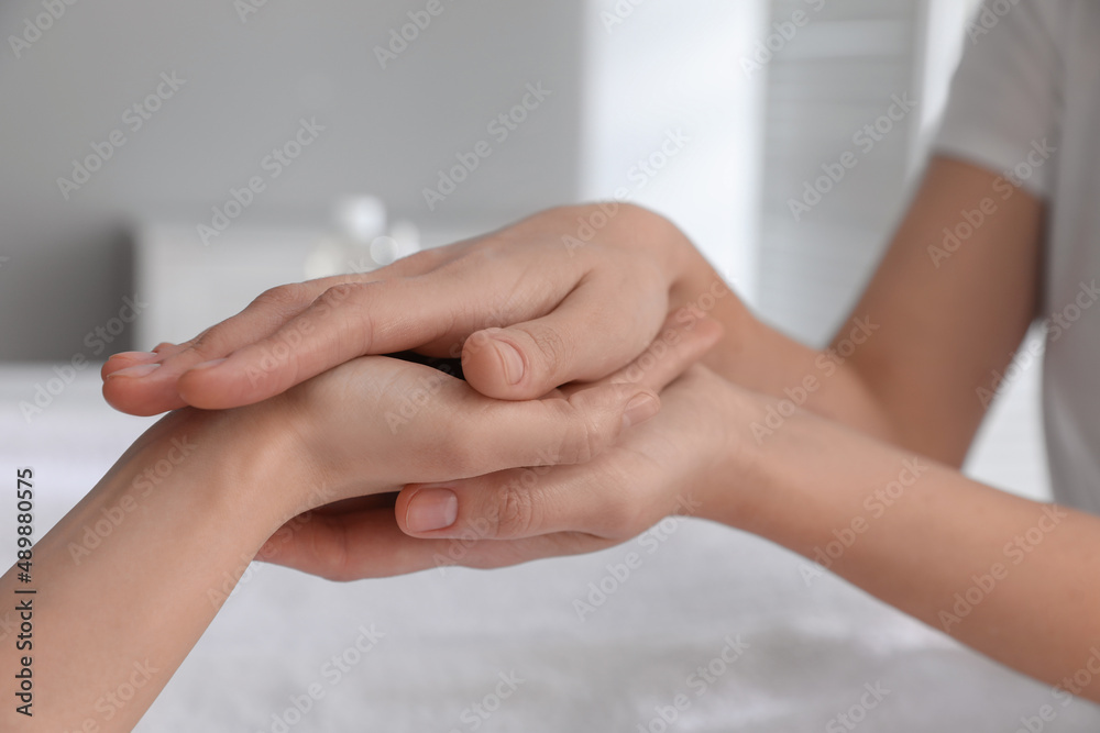Woman receiving hand massage in wellness center, closeup Woman receiving hand massage in wellness center, closeup