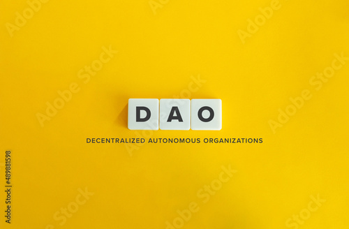 Decentralized Autonomous Organizations (DAO) Banner. Letter Tiles on Yellow Background. Minimal Aesthetics. photo