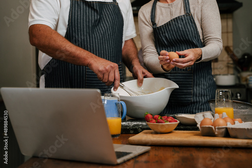 Close up caucasian mature couple baking in kitchen together