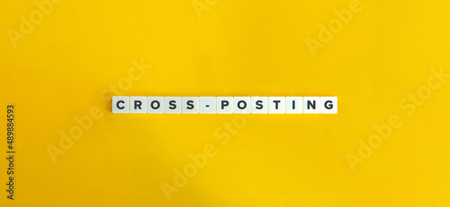 Cross-posting Buzzword on Letter Tiles on Yellow Background. Minimal Aesthetics. photo