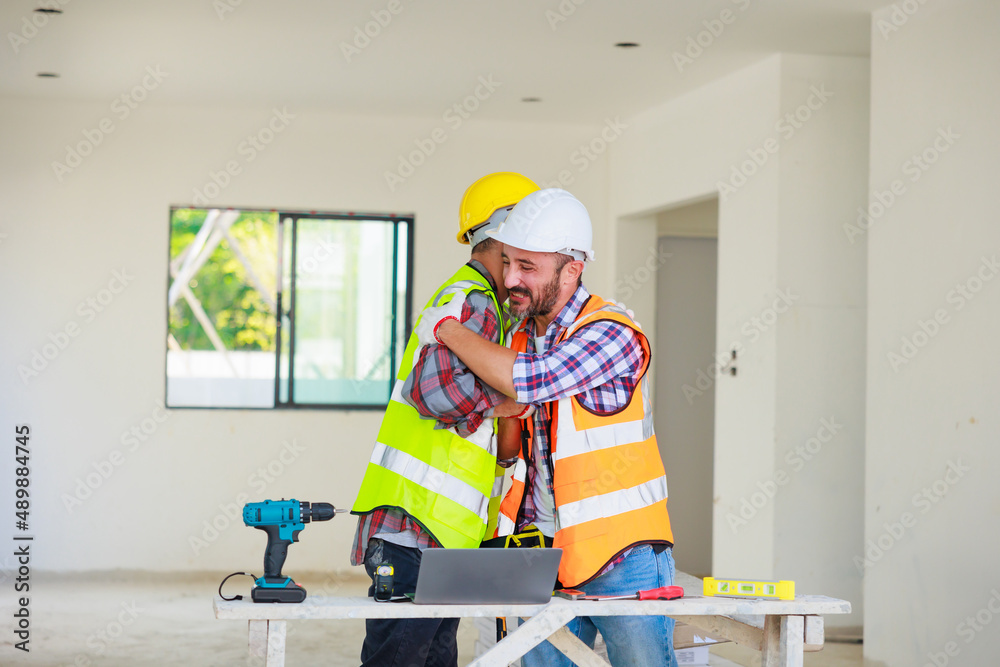 handshake. Electrician and construction engineer man team in safety uniform working and planing in construction site. handshake. Electrician and construction engineer man team in safety uniform working and planing in construction site.