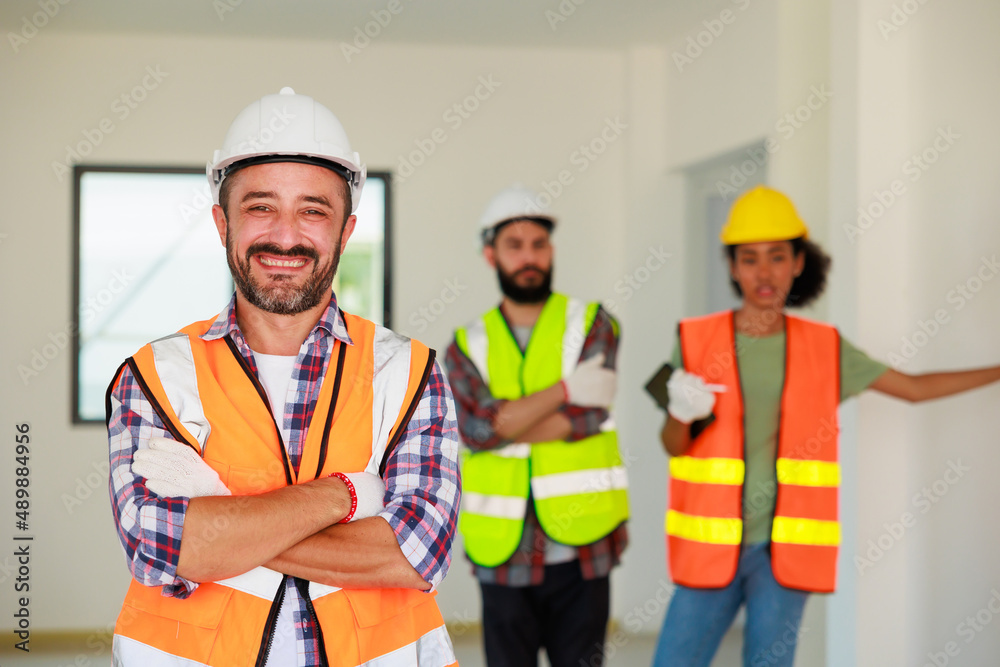 Portrait happy hispanic Construction Worker in safety hard hat helmet working on Building Site. Portrait happy hispanic Construction Worker in safety hard hat helmet working on Building Site.
