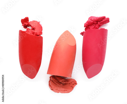 Different beautiful lipsticks on white background, top view