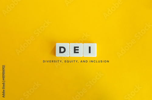 Diversity, Equity, and Inclusion (DEI) Banner. Letter Tiles on Yellow Background. Minimal Aesthetics. photo