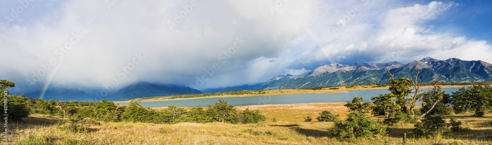 Rainbow over Roca lake and Andes mountains in Argentina