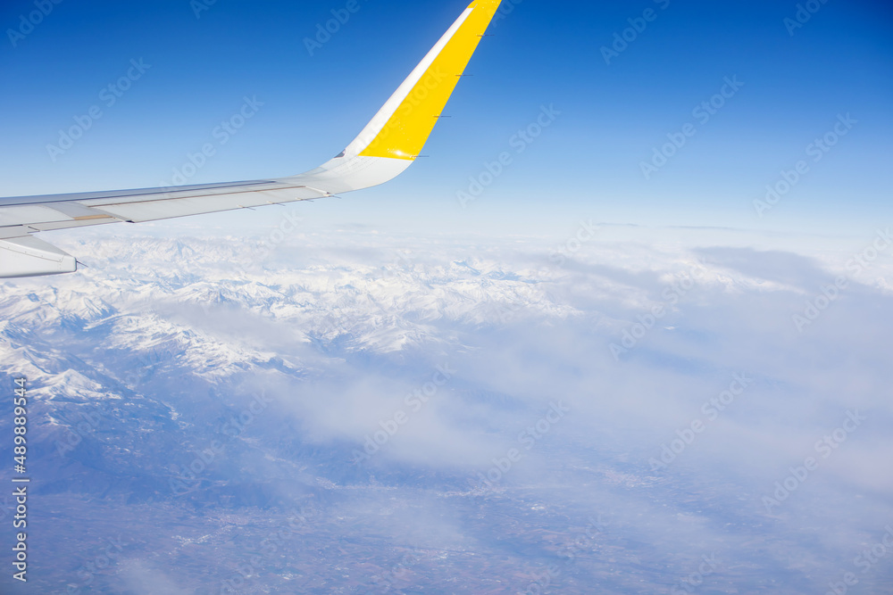 Panoramic view of snowy Alps from above, view from airplane window Panoramic view of snowy Alps from above, view from airplane window