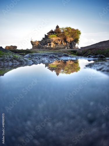 tanah lot temple in the morning with water reflection