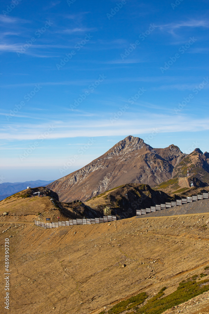 A magnificent mountain landscape with rocks against a clear blue sky. A tourist destination for lovers of hiking in the mountains