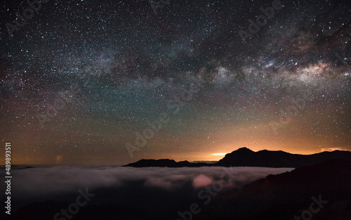 Colorful lighting reflect on the mountain with beautiful galaxy , Hehuan Mountain, Taiwan - the highest mountain in Taiwan Starry Night with Galaxy at Hehuan Mountain