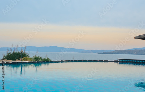 Beautiful crystal blue swimming pool in the background sea and sky