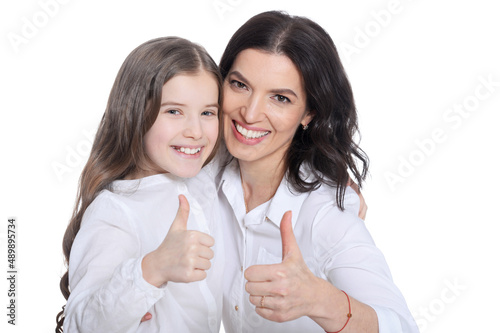 Happy mother and daughter showing thumbs up