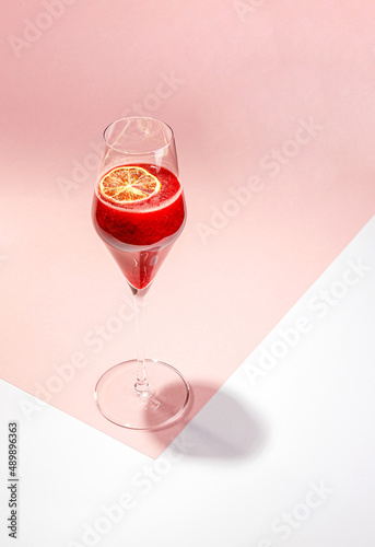 Cold alcoholic or non-alcoholic cocktail on pastel background. Hard light, deep shadow.