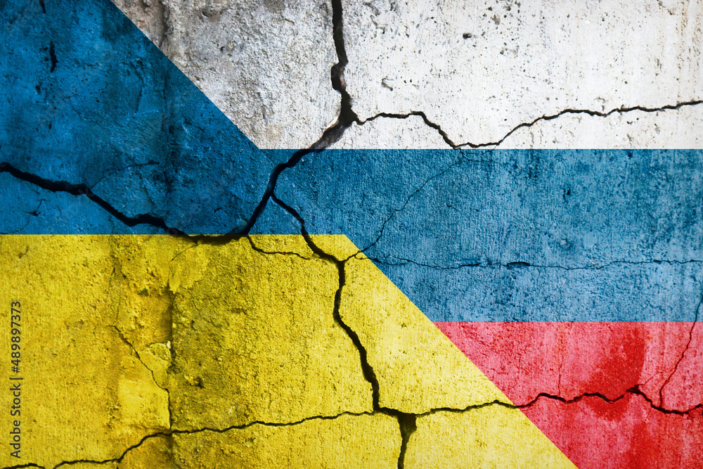 Ukrainian and Russian flags on a cracked wall. A symbol of instability ...