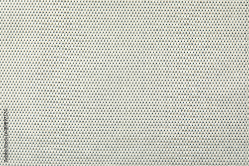 Knitted texture. Texture of jacquard fabric with gray geometric pattern. Crochet mosaic pattern. photo