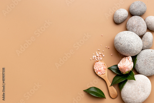 Spa massage stones with pink roses, beauty treatment background
