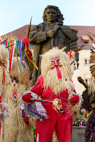 Colorful face of Kurent, Slovenian traditional mask, carnival time. Traditional mask used in februar for winter persecution, carnival time, Slovenia. Prešeren statue in the background.