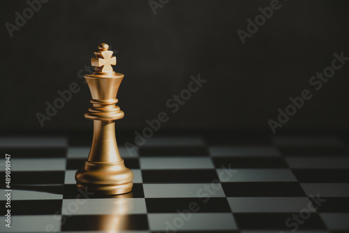 Golden chess kings standing on a board.