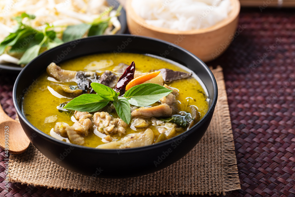 Thai food, Green curry chicken eating with rice noodles and fresh vegetables
