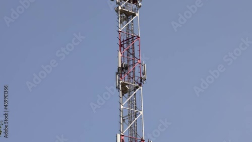 Telecom Tower Antenna Carrying Broadcasting Antennas For Gsm, 3G, 4G And 5G Cellular Networks.  Telecommunications Tower And Satellite Transmits The Signals. Handheld. 4k. ProRes.