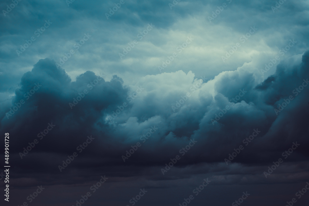 Obraz premium Storm sky with dark grey cumulus clouds. Thunderstorm