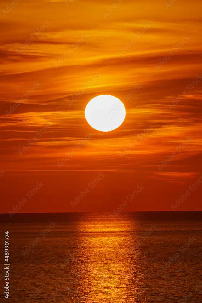  Fantastic sunset over ocean. The sun goes down over the sea. Dramatic Sunset Sky