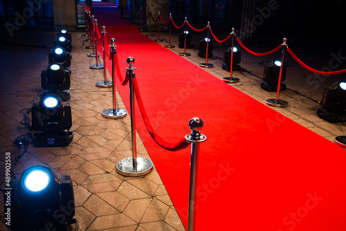 Red carpet with barriers and red ropes.