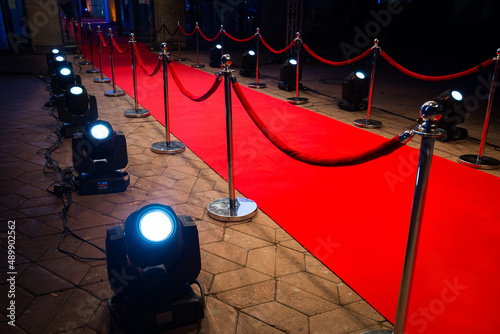 Red carpet with barriers and red ropes.