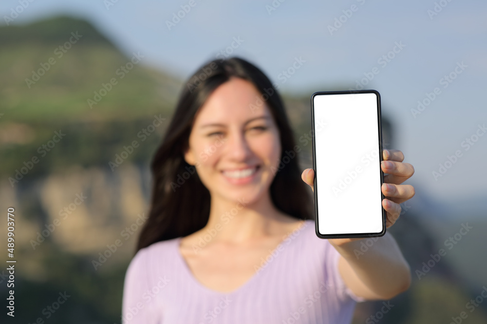Happy asian woman showing blank smart phone screen