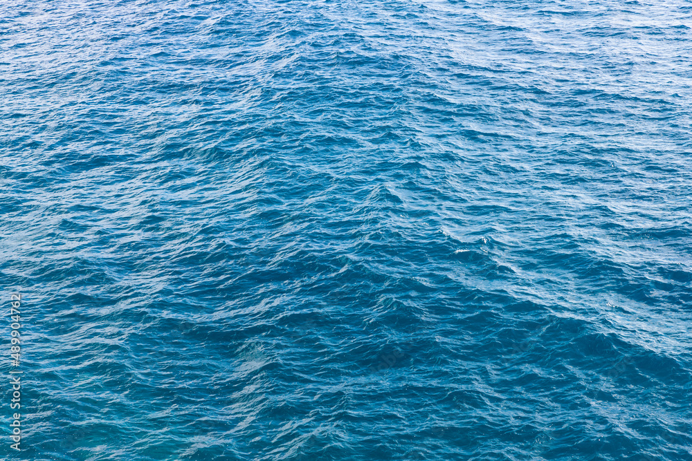 Blue water surface with small waves at sea