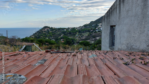 View over a roof at Colle d' orano village on Elba island in Italy and the sea in the morning photo