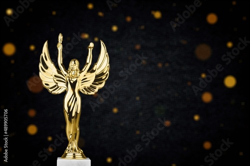 Golden metal trophy cup. Festive light background.