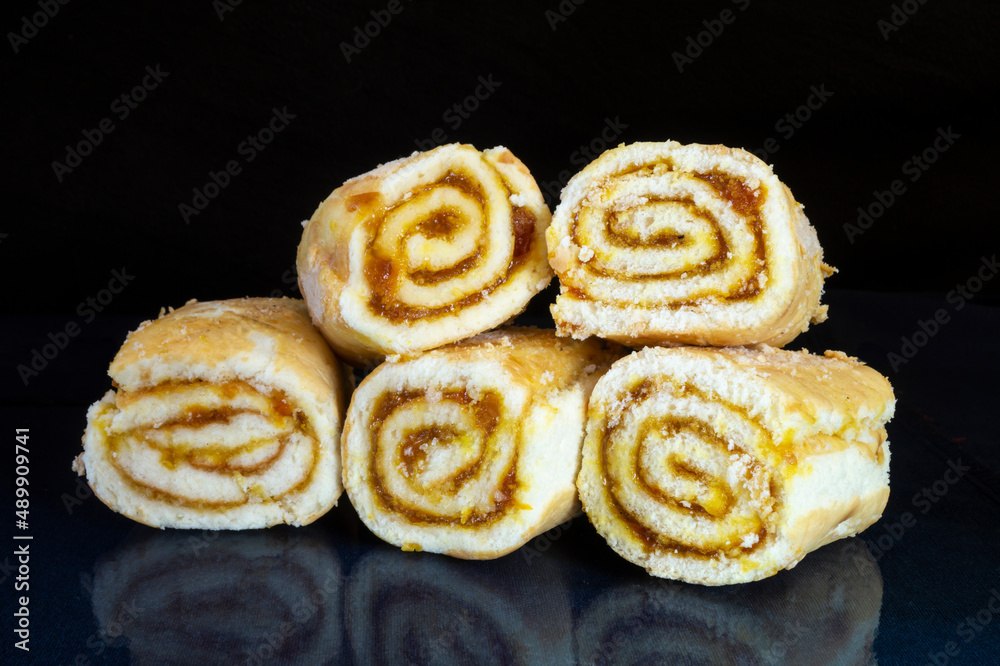 Sweet rolls with stuffing on the table with reflection