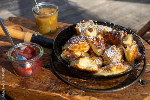 Austrian Kaiserschmarrn in a pan with apple sauce and plum jam