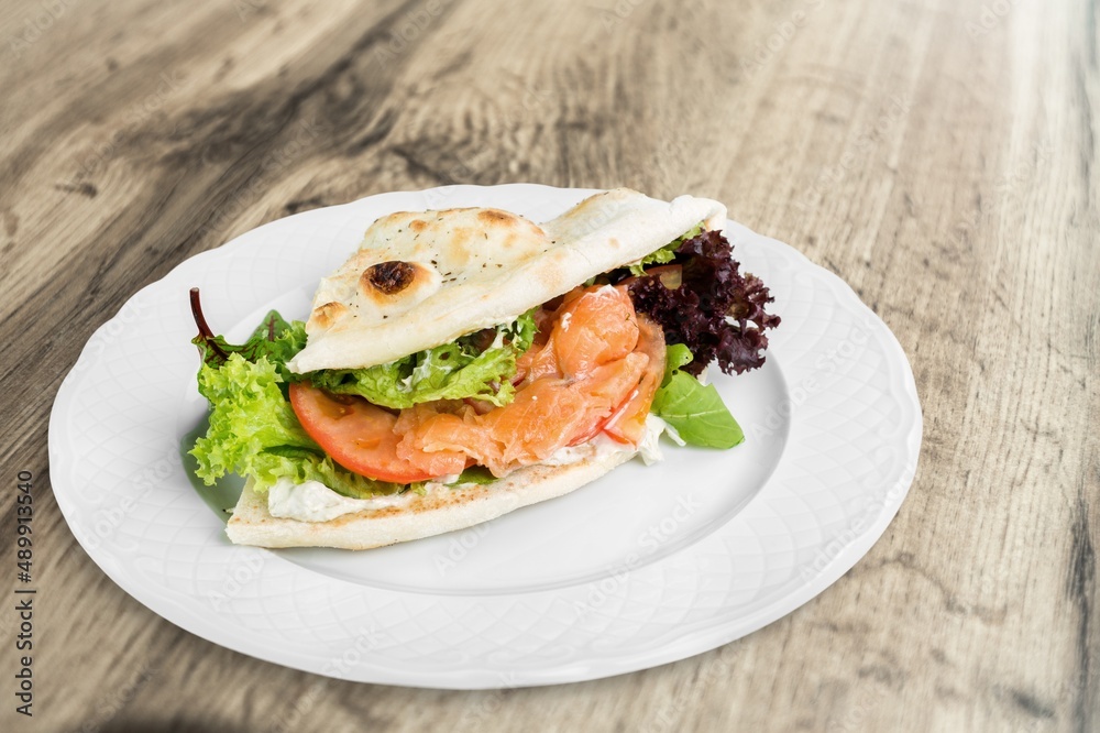 Tasty fresh sandwich on wood background white plate Tasty fresh sandwich on wood background white plate