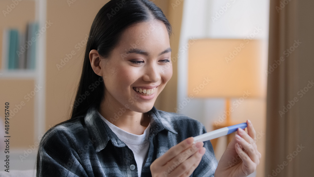 Asian girl pregnant happy girl surprised woman expectant future mother female parent holding looking at positive pregnancy test expecting baby infant childbirth parenthood fertility female gynecology Asian girl pregnant happy girl surprised woman expectant future mother female parent holding looking at positive pregnancy test expecting baby infant childbirth parenthood fertility female gynecology