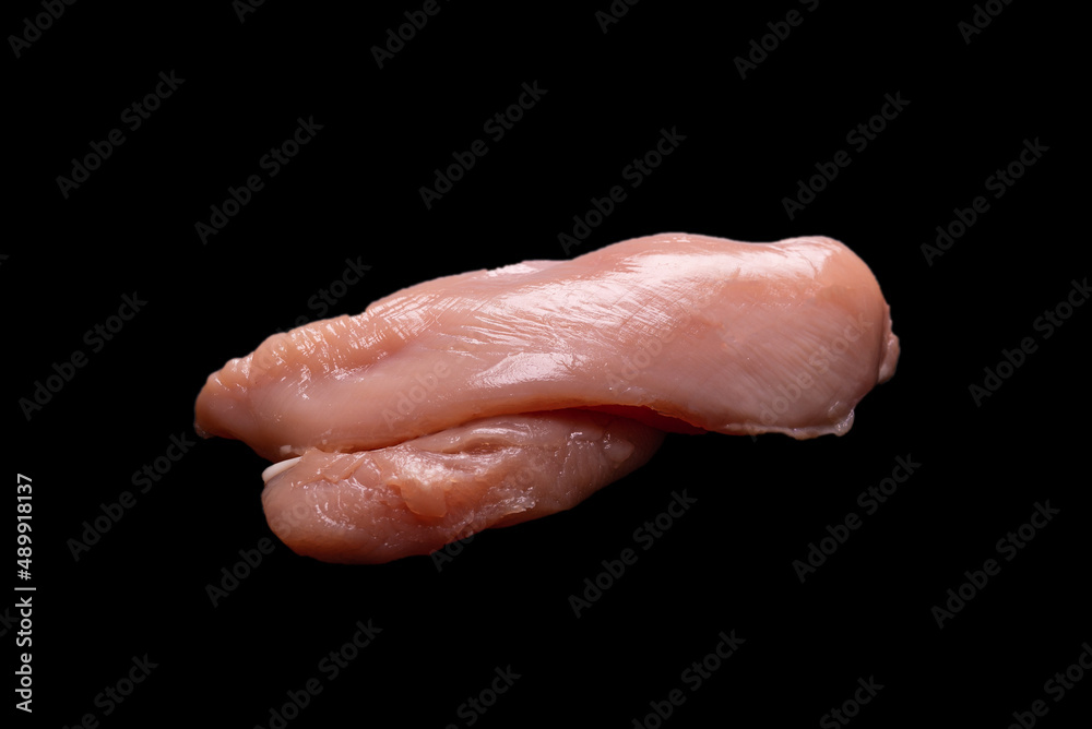 Raw chicken fillet isolated on a black background. Raw chicken fillet isolated on a black background.