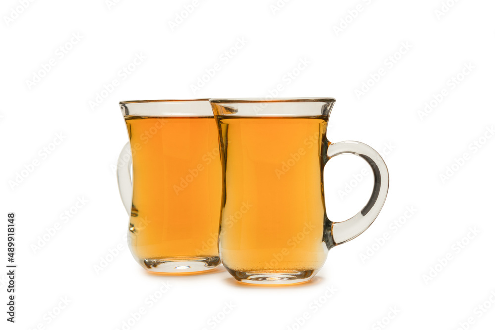 A turkish glass of tea isolated on white background. A turkish glass of tea isolated on white background.