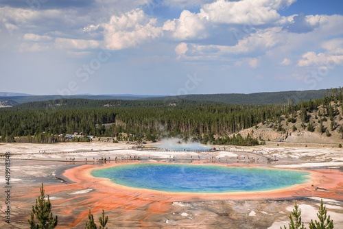 Tourists walk past through Grand Prismatic Springs in Yellowstone.